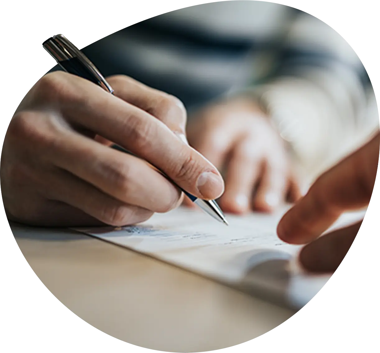 close up of a hand filling out paperwork