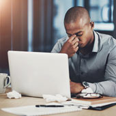 man-suffering-from-covid-while-sitting-at-his-computer